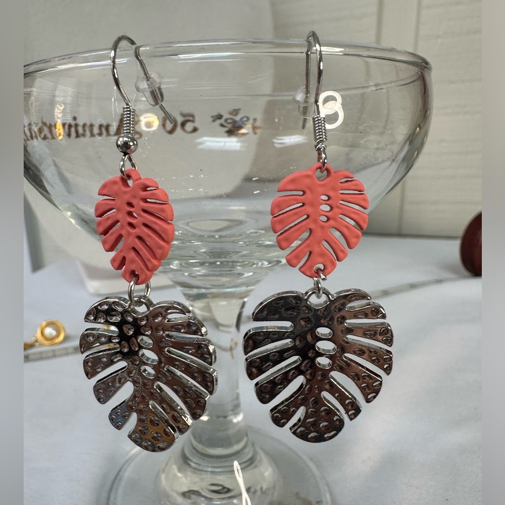 Silvertone and peach monstera leaf dangle earrings